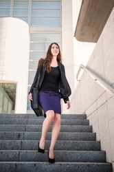 Business woman walking in hurry on stairs